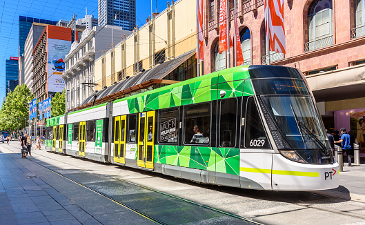 Melbourne, Victoria, Australia, October 29th, 2019: A Melbourne city tram is traveling down the Bourke Street Mall on a blue sky day.