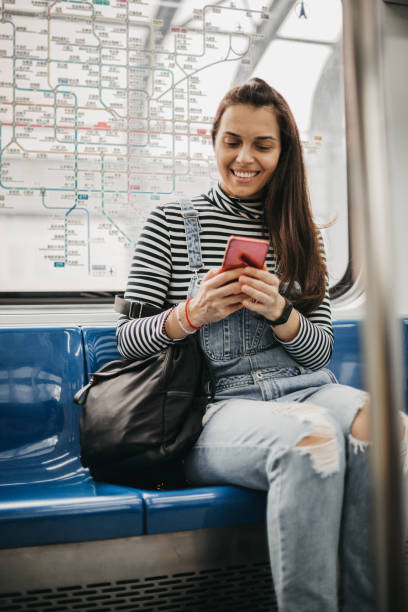 istock Woman inside subway train looking at her smartphone 1187039809