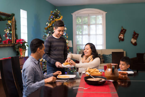 mexican family on christmas eating together - 6 12 months imagens e fotografias de stock