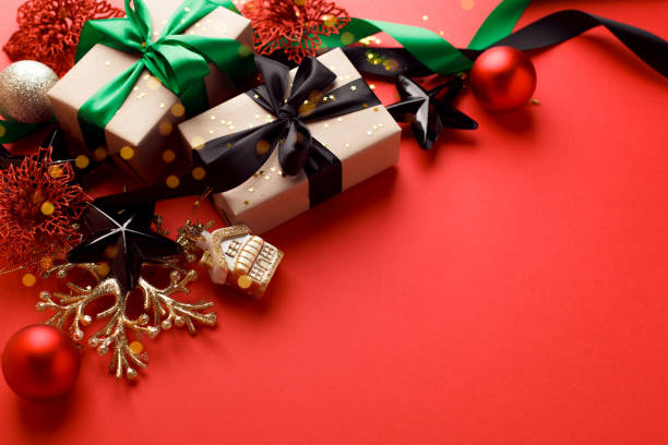 istock Christmas black red gold decor and handmade gift box on red background top view. Merry Christmas greeting card, frame. Winter xmas holiday theme, New Year. Sale 1187042784
