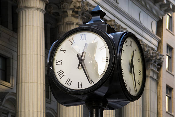 istock clock street reflecting building image on glass surface 118704362