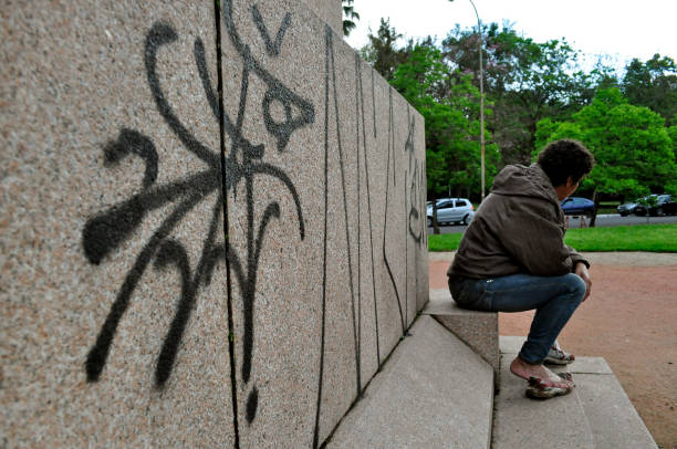 A homeless sits on a vandalized monument Porto Alegre/Rio Grande do Sul/Brazil - 08/10/2010: A homeless sits on Israeli Column vandalized monument desecrate stock pictures, royalty-free photos & images