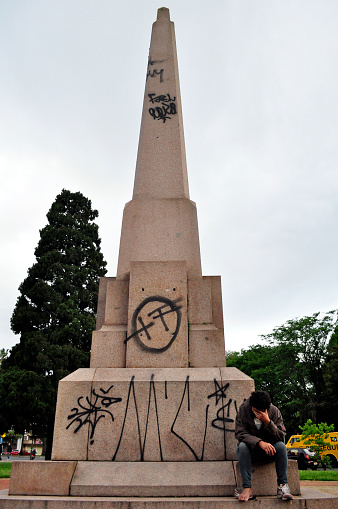 Porto Alegre/Rio Grande do Sul/Brazil - 08/10/2010: A homeless sits on Israeli Column vandalized monument