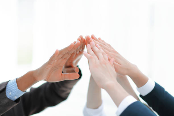 istock closeup.business team giving each other a high five. 1187057243
