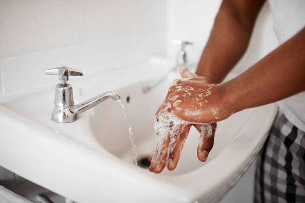 always start with clean hands - washing hands hygiene human hand faucet imagens e fotografias de stock