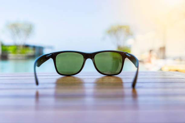 istock Sunglasses on wooden table at the beach.  Object for holiday concept 1187065910