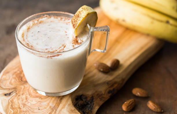 istock Fresh Made Chocolate Banana Smoothie on a wooden table. Selective focus. Milkshake with nuts. Protein diet. Healthy food and drink concep 1187067031