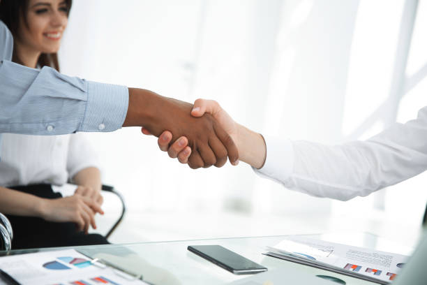 istock closeup.the financial partners shaking hands over a Desk. 1187068046