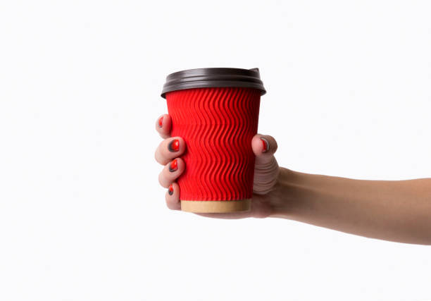 istock Females hand with red black ombre gradient nails hold paper cup 1187077683