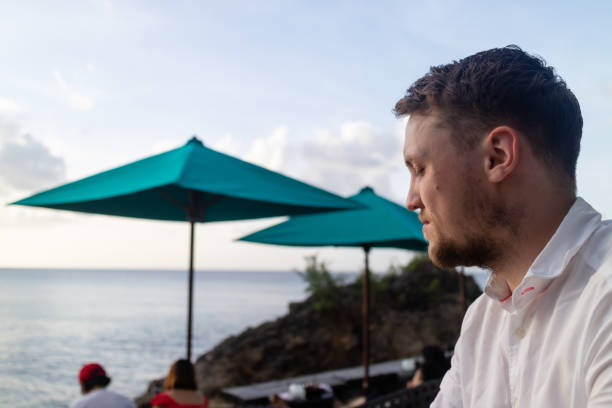 istock A young man relaxing on holiday in a tropical destination 1187078697