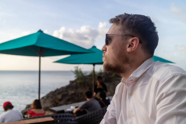 istock A handsome young man in sunglasses on holiday 1187078712