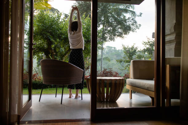 istock A woman doing morning stretches while looking at tropical scenery 1187078741