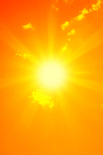 istock Bright sun with beautiful beams in the sky with clouds (toned in red) 1187078845