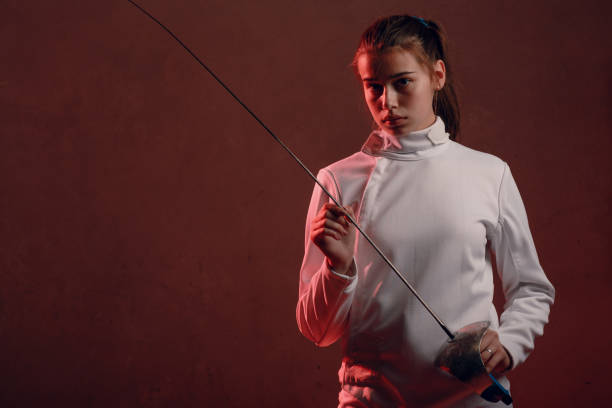 istock Fencer woman with fencing sword. 1187082589