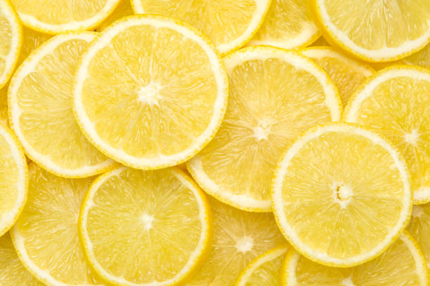 fresh lemon slices pattern background, close up - lemon imagens e fotografias de stock