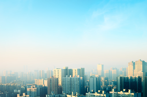 World Habitat Day concept: Blurred city and blue sky background