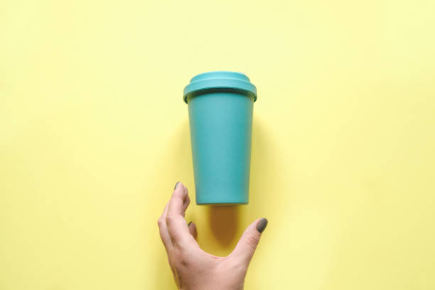 istock A woman's hand reaches for her coffee mug 1187086290