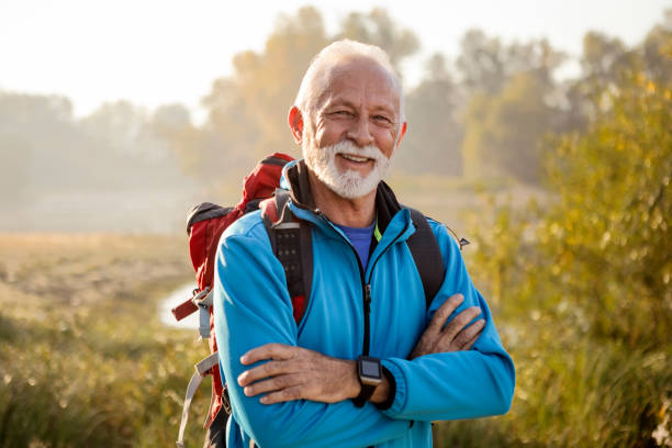 istock Senior man on a footpath hiking posing with smile 1187088036
