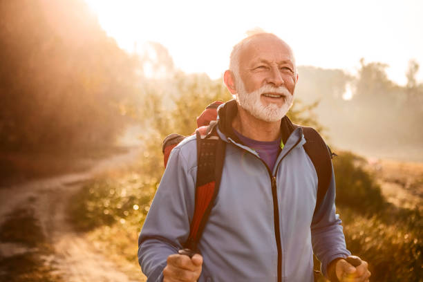 istock Senior man on a footpath enjoying hiking smiling along 1187088066