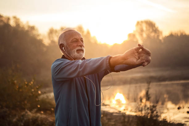 istock Mature man stretching arms getting ready for training in morning time 1187088081