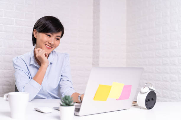 istock Happy woman sitting at home office working using computer laptop 1187093574