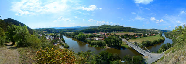 istock Panoramic view of the valley with small houses, fields, river and bridge 1187093813
