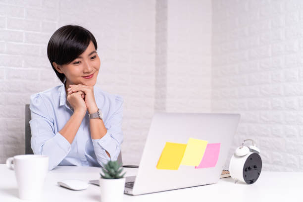 istock Happy woman sitting at home office working using computer laptop 1187094442