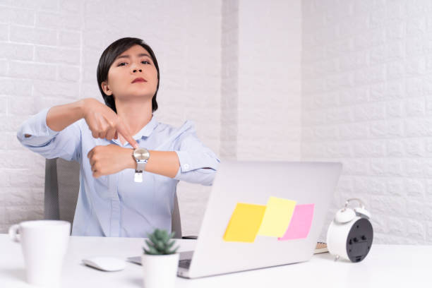 istock Angry woman pointing at her watch 1187095056
