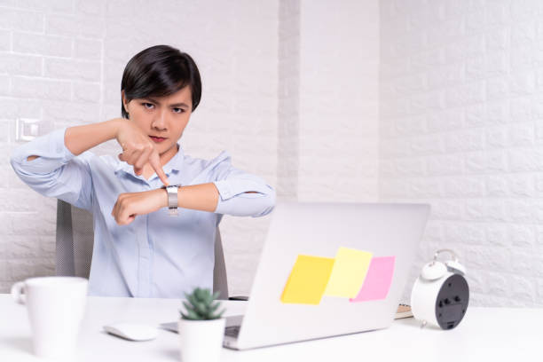 istock Angry woman pointing at her watch 1187096764