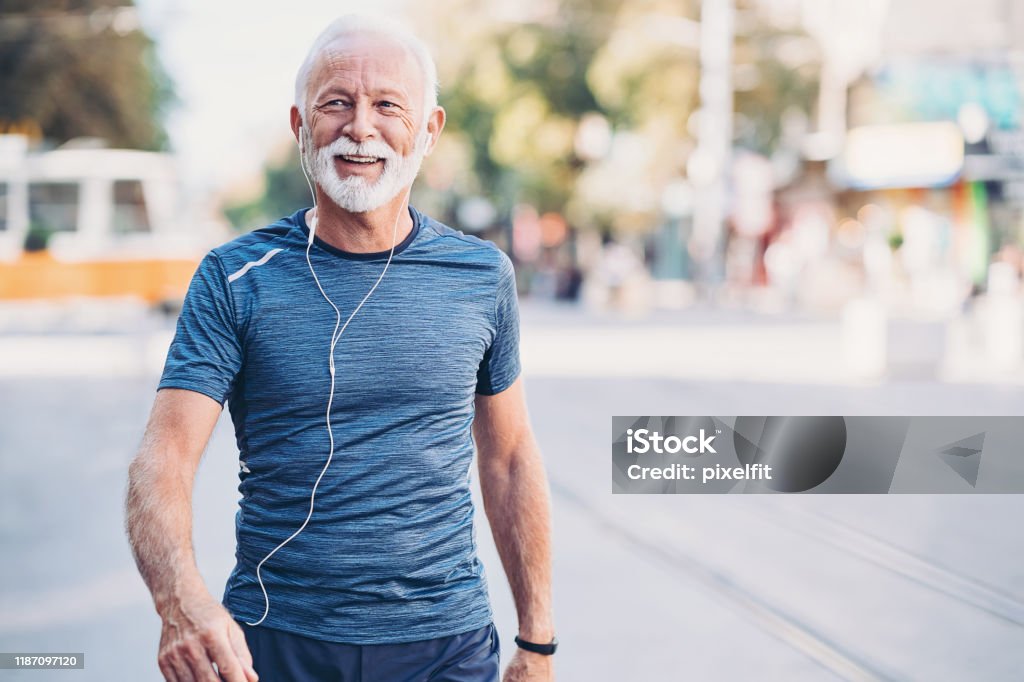 Healthy lifestyle Senior athlete walking outdoors in the city Senior Adult Stock Photo