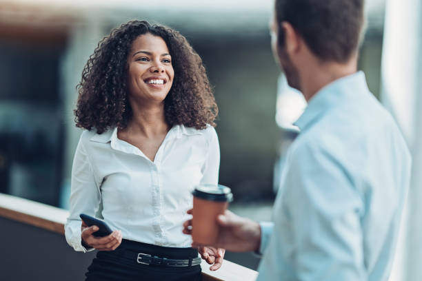 istock Business couple chatting in the corridor 1187097130