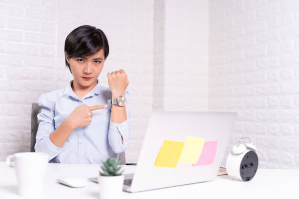 istock Angry woman pointing at her watch 1187097955