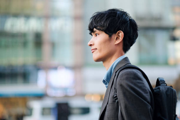 Closeup of businessman walking on street Asian young businessman walking on street japanese ethnicity stock pictures, royalty-free photos & images