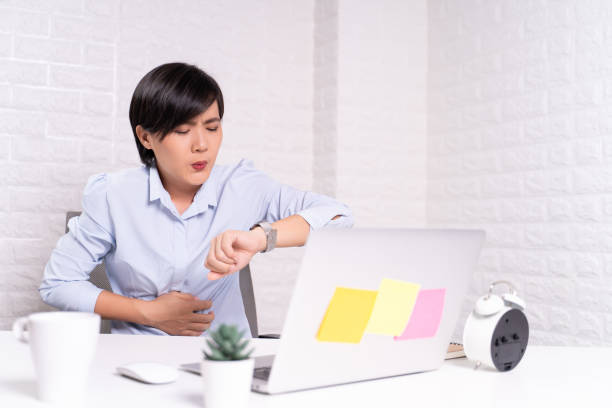 istock Woman has stomachache at office 1187100323