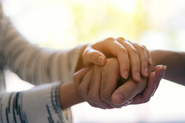 istock A man and a woman holding each other hands for comfort 1187100334