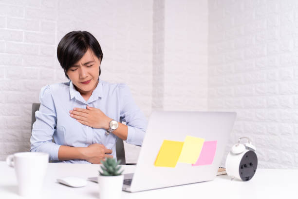 istock Woman has stomachache at office 1187100366