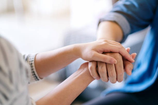 istock A man and a woman holding each other hands for comfort 1187100384