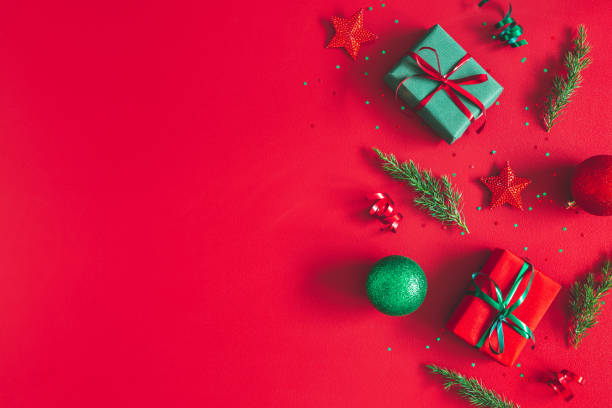 istock Christmas composition. Gift box, christmas decorations on red background. Flat lay, top view, copy space 1187100462