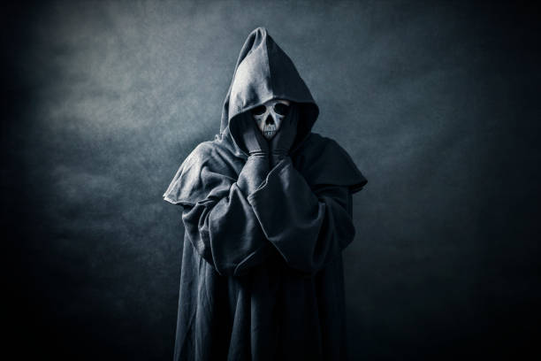 istock Ghostly figure in hooded cloak 1187101887