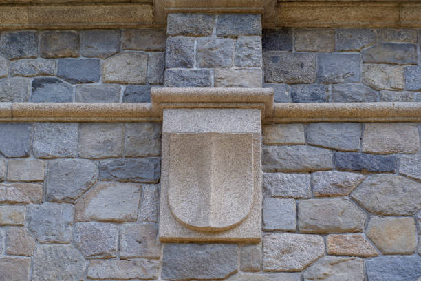 istock Empty decorative shield for a coat of arms on a stone wall 1187103076