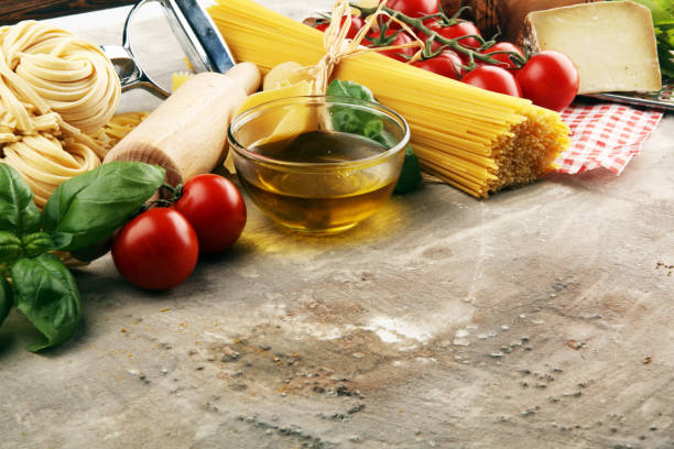 istock Pasta, vegetables, herbs and spices for Italian food on rustic table 1187105305