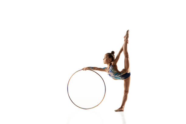 istock Little flexible female gymnast isolated on white studio background 1187108245