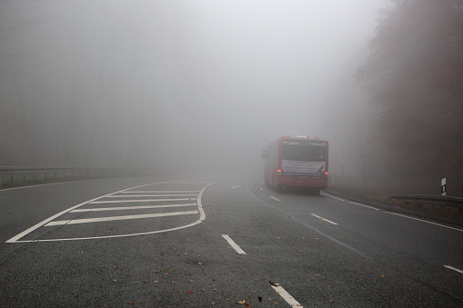 Taunusstein, Germany - November 12, 2019: Traffic on foggy road between Wiesbaden and Taunusstein in Rheingau-Taunus area on autumnal day