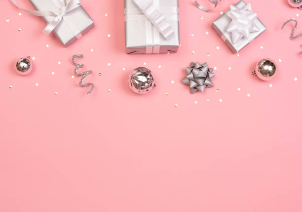 istock Christmas composition with decorations and gift box with star confetti on pink pastel background. winter, new year concept. Flat lay, top view, copy space. 1187109625