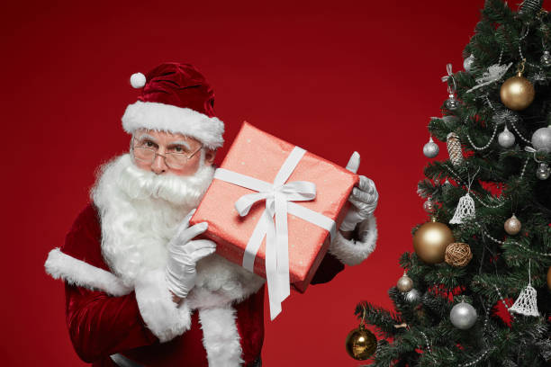 istock Santa Claus with Christmas present 1187110082