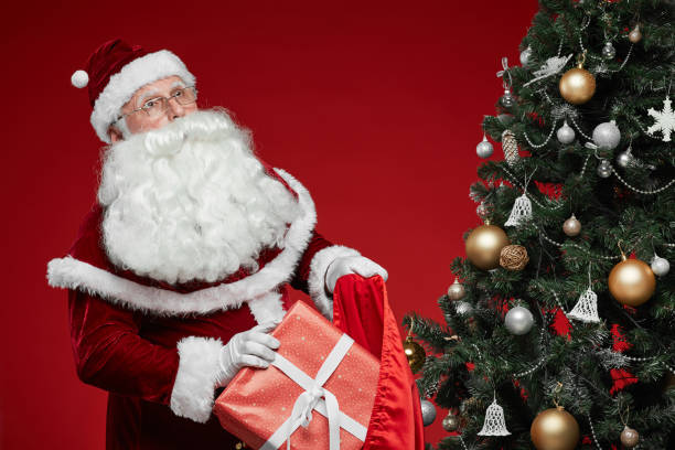 istock Santa preparing presents for holidays 1187110676