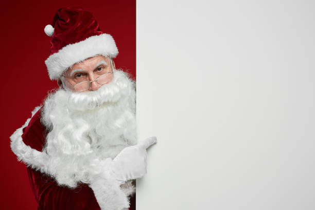 istock Santa Claus pointing at placard 1187111404
