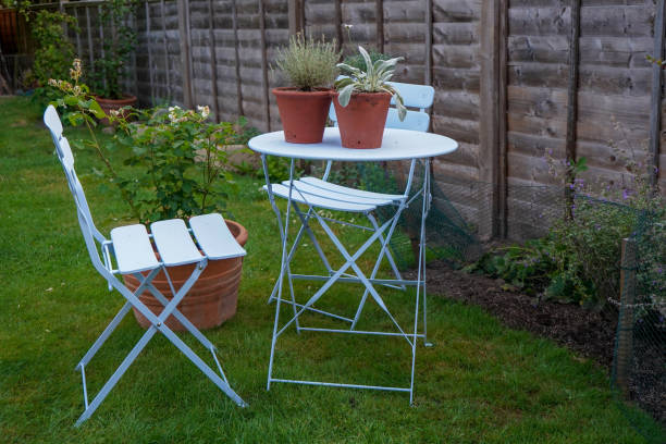 garden table and chair with plants on it - hydrangea gardening blue ornamental garden imagens e fotografias de stock