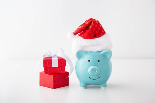 istock Piggy bank with christmas hat and gift box 1187113032