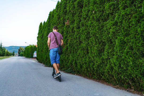 istock Young man driving electric scooter 1187113180